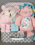 Baby girl hamper gift to include soft toy, pink bath robe, baby booties and chocolates for the parents.