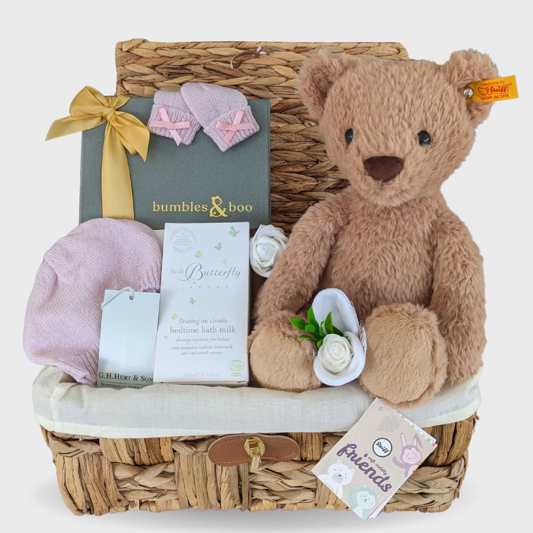 baby girl hamper with steiff teddy bear, chocolates for the parents, organic baby skincare and luxury cashmere clothing.