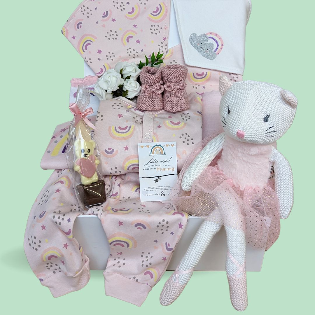 Beautiful baby girl hamper with knitted soft ballerina toy, soft cotton clothing set with rainbow and star theme, baby booties, chocolate and bracelet for mummy.