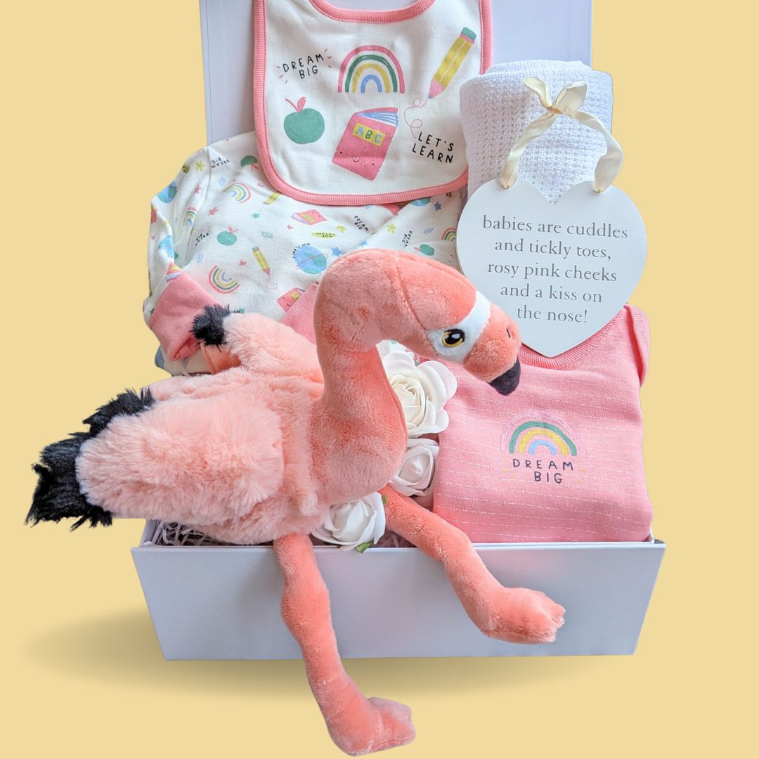 baby girl hamper box with organic clothing set and flamingo toy.