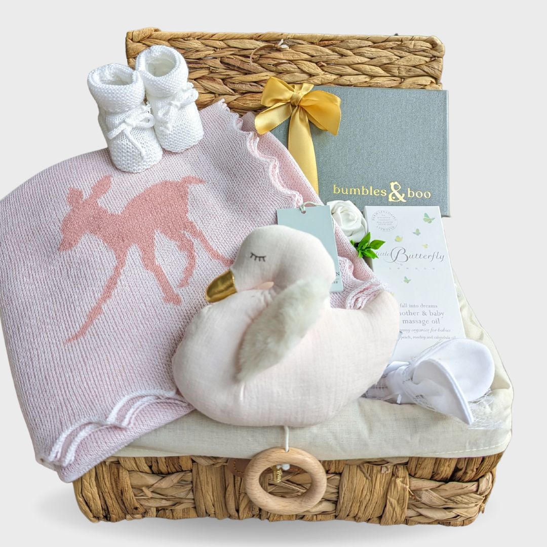 New Mum and Baby girl hamper basket with wool blanket, chocolates for the parents and gifts for baby.