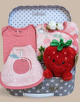 baby girl hamper trunk with clothing set and strawberry soft toy.