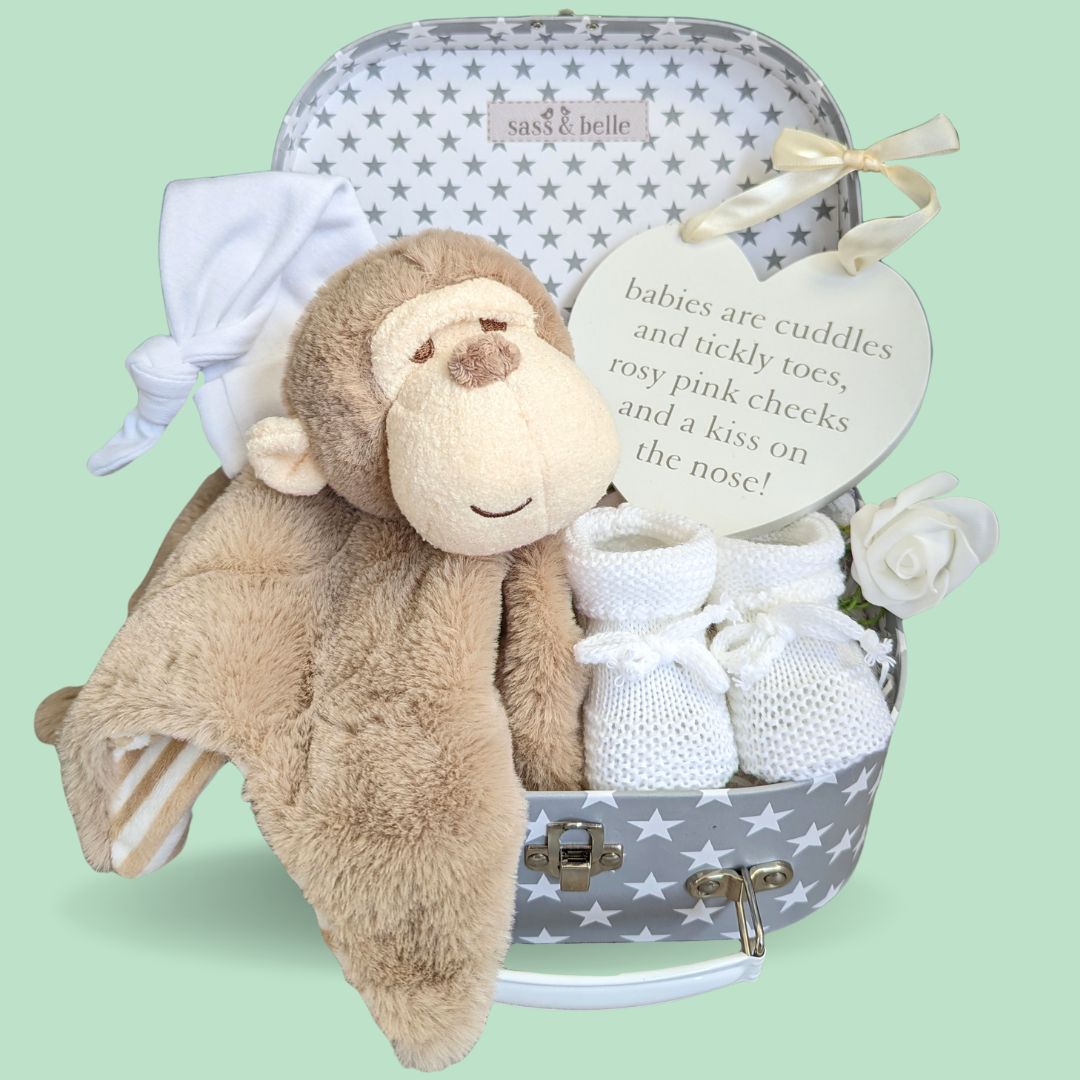 new baby hamper gift with monkey comforter, baby hat, nursery plaque and baby booties.