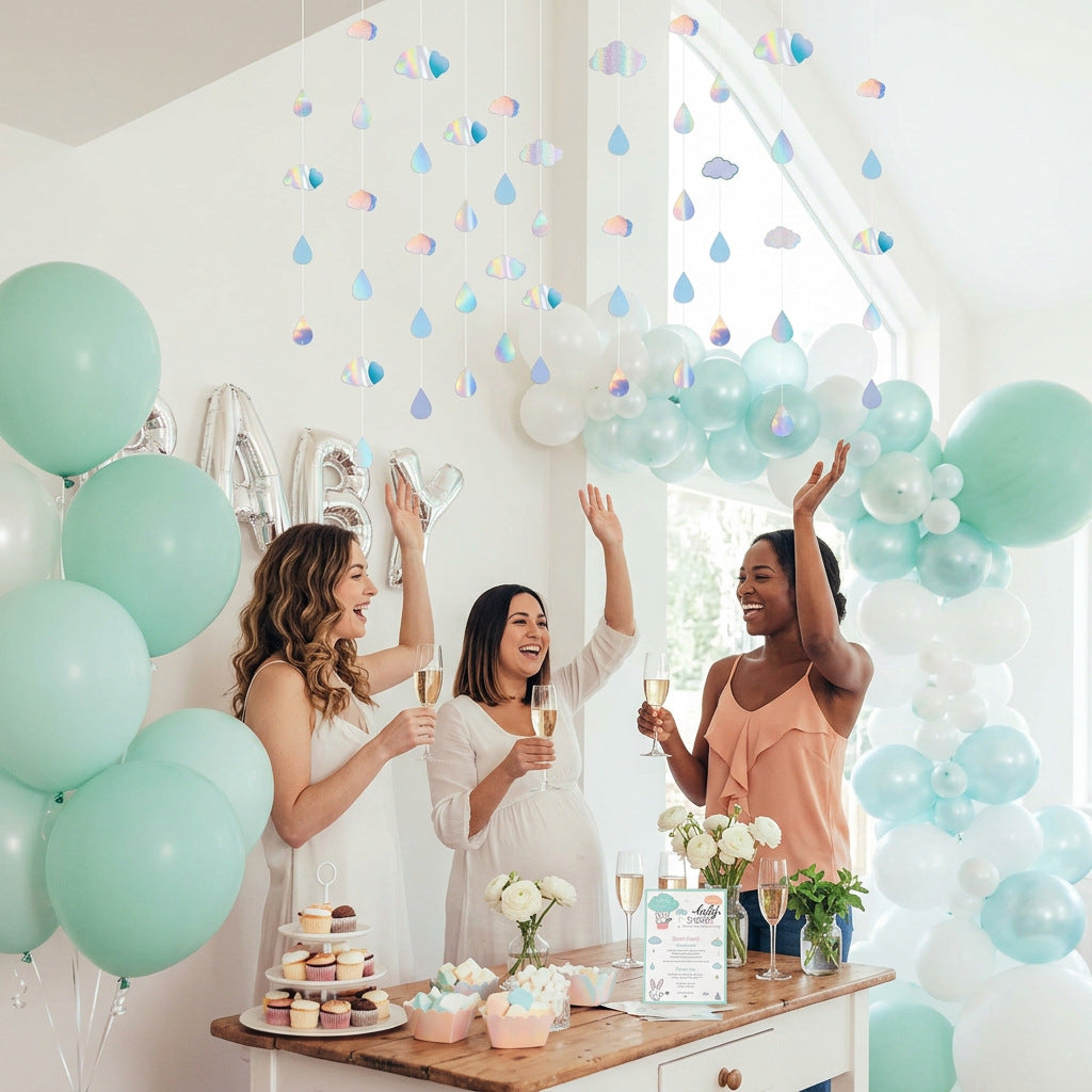 Shimmering cloud and raindrop decorations hanging above a pastel baby shower party.