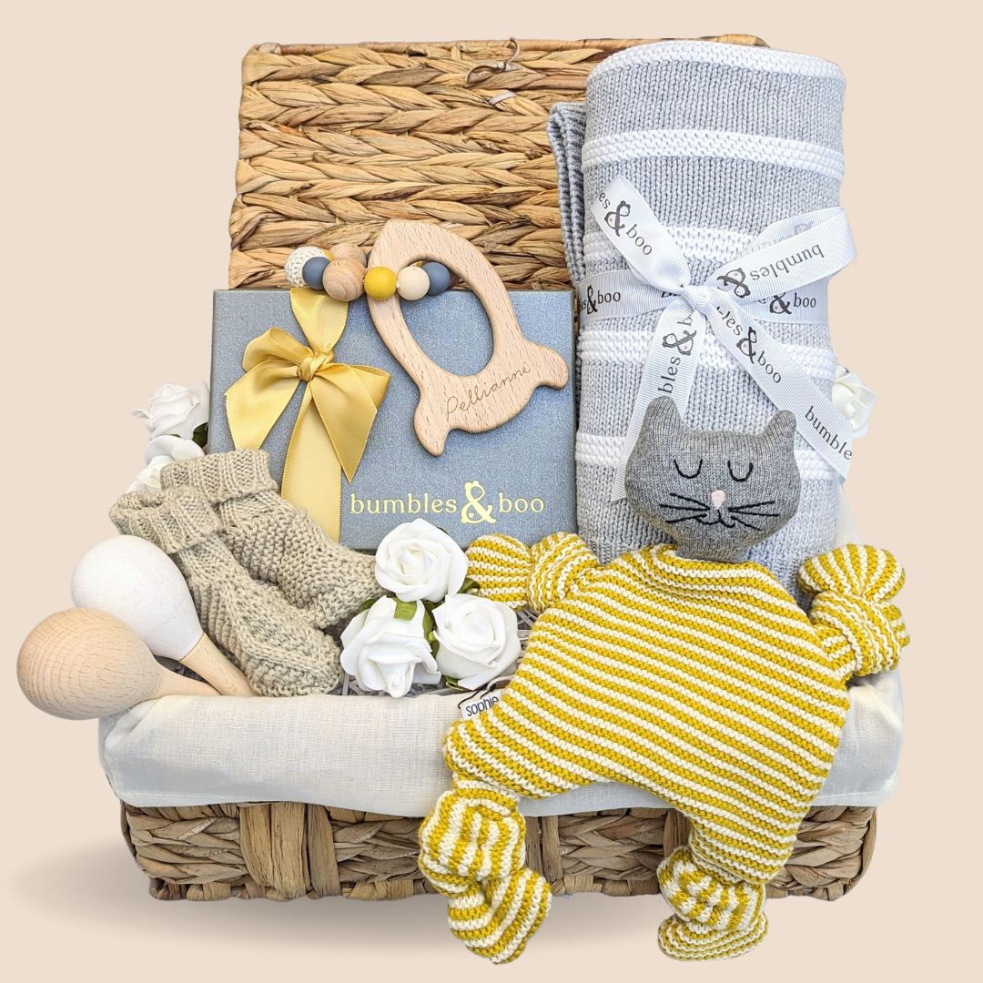 Baby shower gifts basket with soft knit comforter toy, baby booties, knit blanket, rocket teether & chocolates.