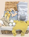 Baby shower gifts basket with soft knit comforter toy, baby booties, knit blanket, rocket teether & chocolates.