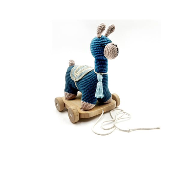 A handcrafted blue llama pull along toy made of organic cotton with wooden wheels, displayed on a white background.