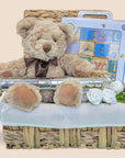 christening gift hamper with birth certificate holder, teddy bear and wooden building blocks.