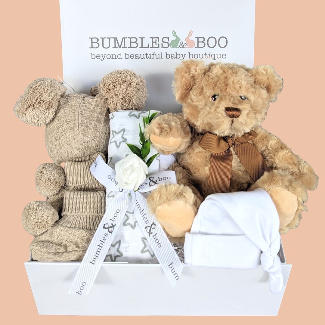 Unisex hamper gifts with teddy bear, muslin wrap, baby booties and hat.
