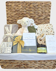 New mum gifts hamper basket with organic blanket, muslin wrap, organic skincare, lamb soft toy and money box.