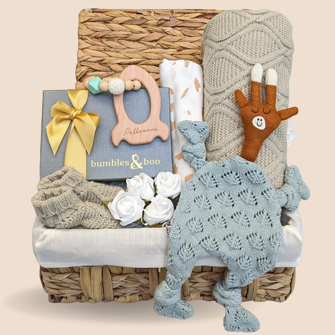 Stunning baby shower hamper which comprises soft knit comforter toy, baby booties, knit blanket, rocket teether & delicious chocolates for the new mum.