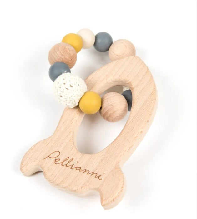 Rocket shaped wooden teether in muted tones.