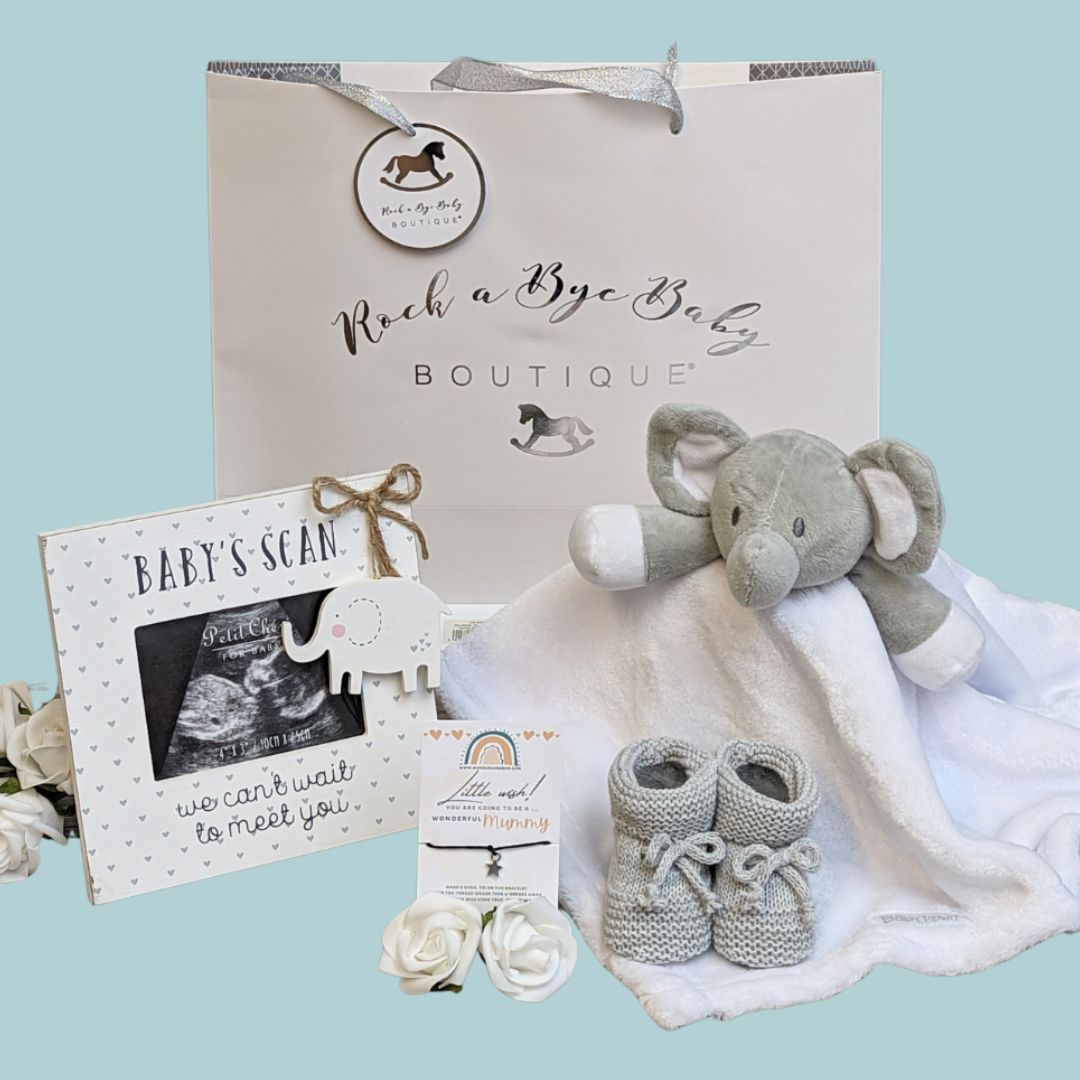 pregnancy gift bag with photo frame, wish bracelet, baby booties and elephant comforter.
