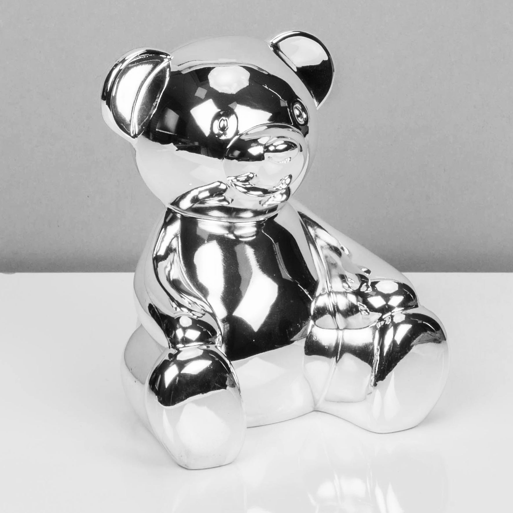 Silver plated teddy money box. with money slot and bung at base.