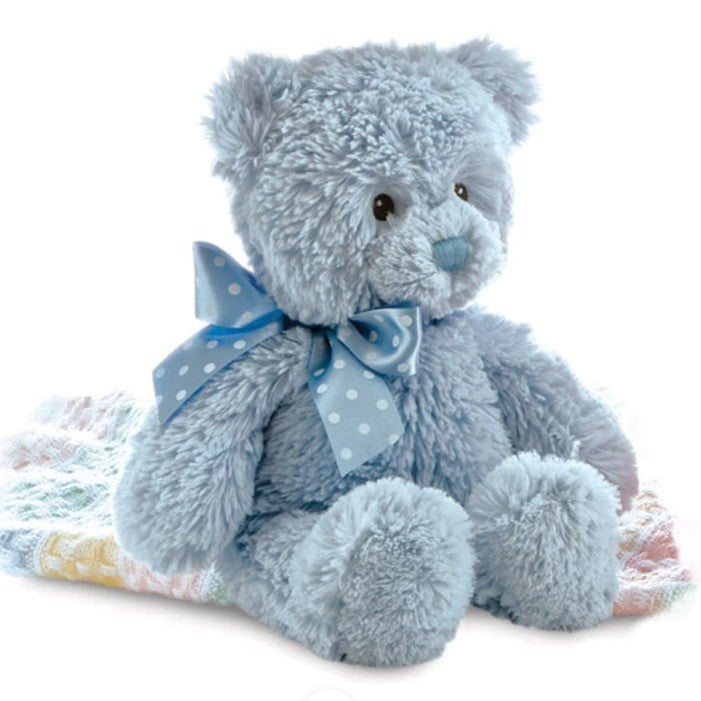 Teddy bear blue in colour with ribbon around his neck.