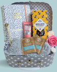 Treat gift box hamper trunk with chocolates, journal, organic tea and body lotion.