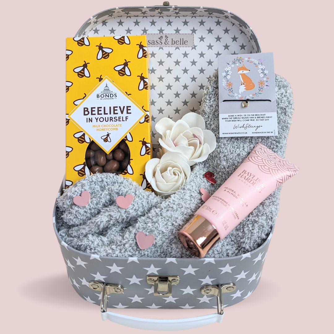 Treat box gifts hamper with chocolates, body lotion, bracelet and socks.