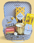 Treat box gifts hamper with bee happy theme. Chocolates, candle, bracelet and balm.