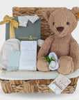 baby shower hamper gifts with cashmere mittens and hat, baby skincare, chocolates and steiff teddy bear.