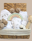 baby hamper gift with organic teddy hand rattle, baby clothing set, pom pom hat and mittens.