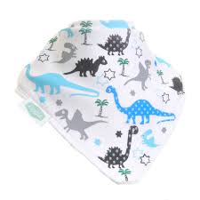 Close view of Ziggle's white bandana bib showing blue, grey and black dinosaurs with green trees.